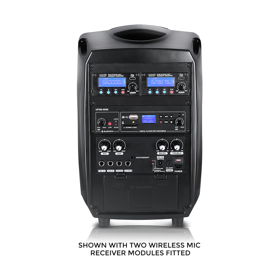 A black portable PA speaker system shown from the front on a white background, with two wireless microphone receiver modules attached. The front panel features blue digital displays, multiple rotary knobs, and various input/output ports.